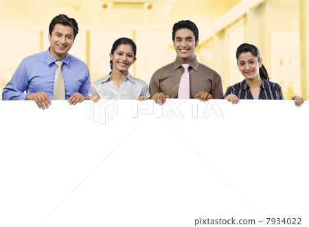 Businesspeople holding a placard Businesspeople holding a placard 7934022