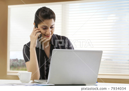 Businesswoman talking on a mobile phone Businesswoman talking on a mobile phone 7934034