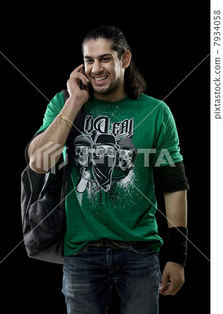Young man talking on a mobile phone 7934058