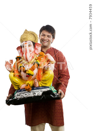 Man carrying a Ganesh idol Man carrying a Ganesh idol 7934459