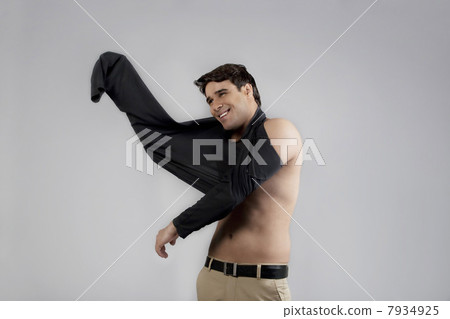 Man putting on a t-shirt Man putting on a t-shirt 7934925