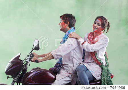 Couple riding on a motorcycle Couple riding on a motorcycle 7934986