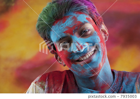 Mans face covered in holi colours Mans face covered in holi colours 7935003