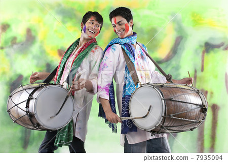 Two men playing on dhols Two men playing on dhols 7935094