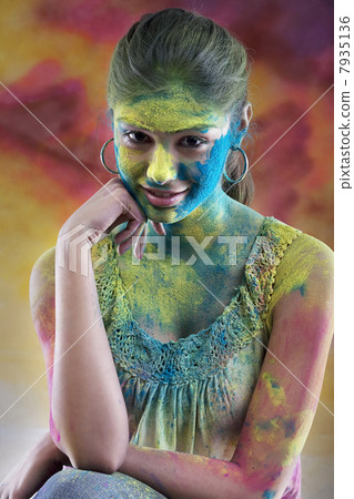 Woman covered in holi colours 7935136