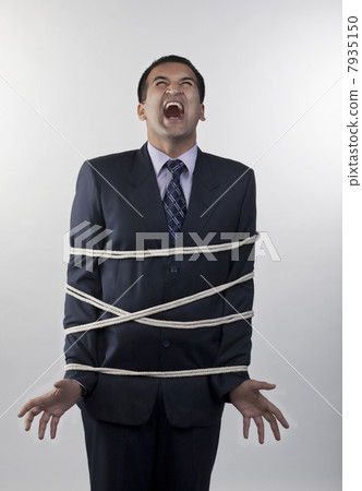 Businessman tied up with rope 7935150