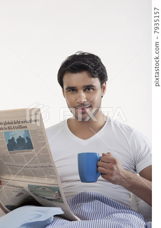 Man with a newspaper and coffee Man with a newspaper and coffee 7935157