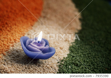 A candle in the middle of coloured pulses 7935390