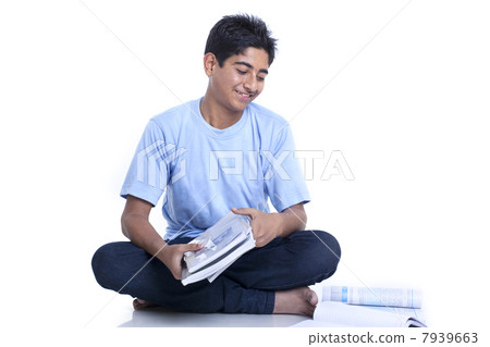Smiling teenage boy with books against white background 7939663
