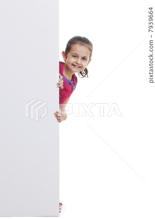 Playful little girl peeking through white board 7939664