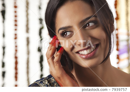 Indian bride talking on a mobile phone 7939757