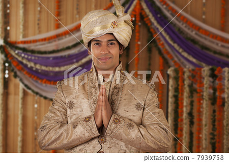 Portrait of Indian groom greeting 7939758