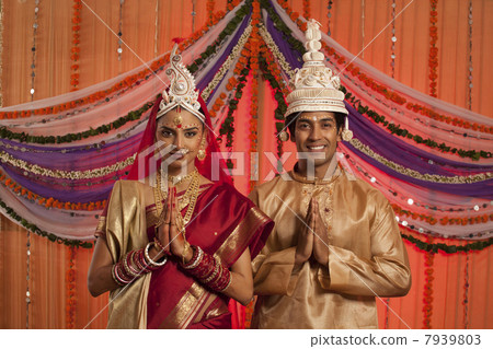 Portrait of Bengali bride and groom greeting 7939803