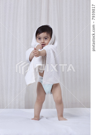 Little boy with a towel wrapped around him 7939817