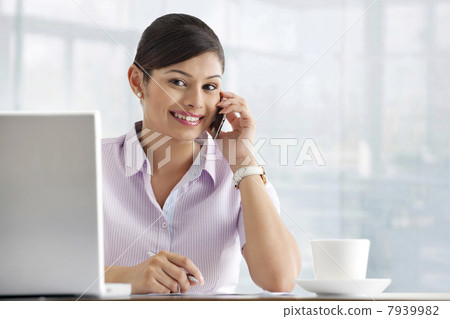 Portrait of pretty female executive using cell phone 7939982