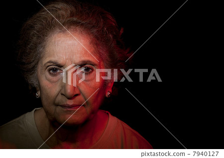 Portrait of senior woman over black background 7940127