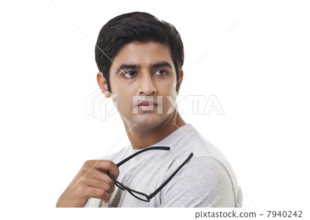 Thoughtful young man looking away over white background 7940242