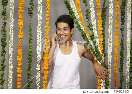 Indian groom talking on a mobile phone 7940285