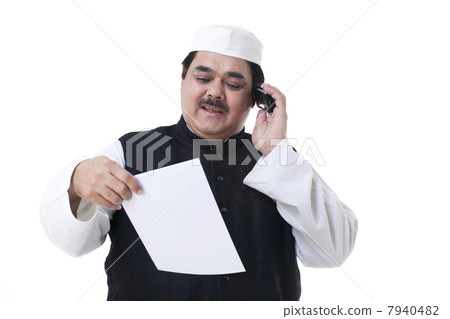 Male politician looking at a document 7940482