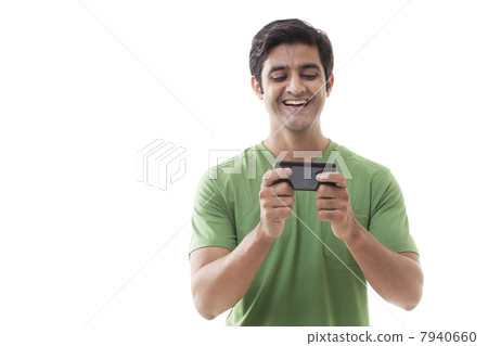 Cheerful young man texting over white background Cheerful young man texting over white background 7940660