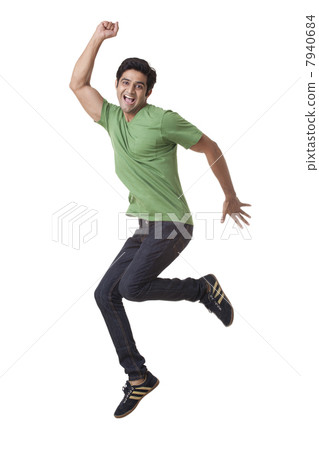 Full length of young man jumping in air 7940684