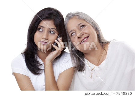 Girl on call while grandmother listening her conversation Girl on call while grandmother listening her conversation 7940880