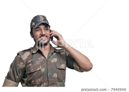 Happy soldier having conversation on mobile phone 7940948