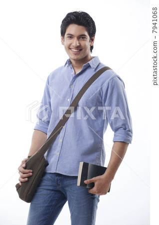 Young man holding book and shoulder bag 7941068