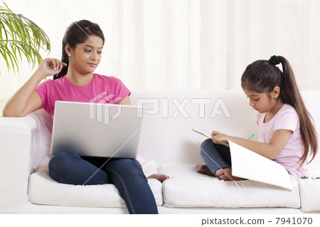 Young woman looking at her daughter 7941070
