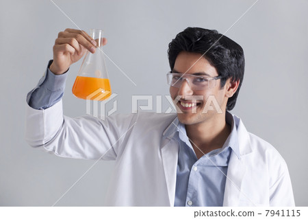 Portrait of scientist smiling and holding flask 7941115