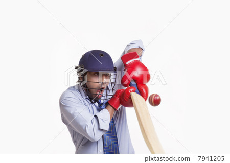 Businessman hitting ball over white background 7941205