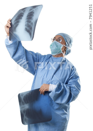 Female doctor looking at chest x-ray 7941251