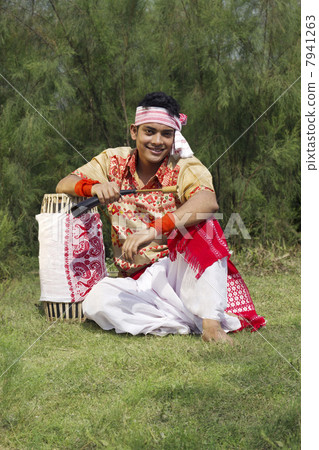 Portrait of a Bihu dancer sitting with a dhol 7941263
