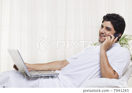 Young man having conversation on mobile phone 7941265