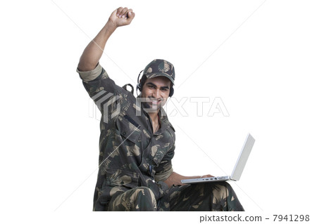 Portrait of happy man celebrating success while using laptop 7941298