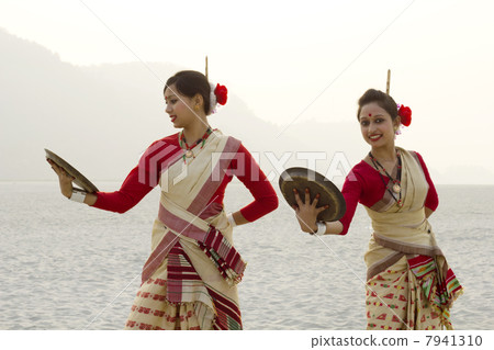 Bihu women dancing with brass plates 7941310