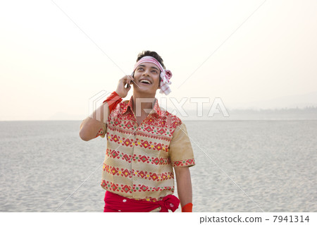 Bihu man talking on a mobile phone Bihu man talking on a mobile phone 7941314