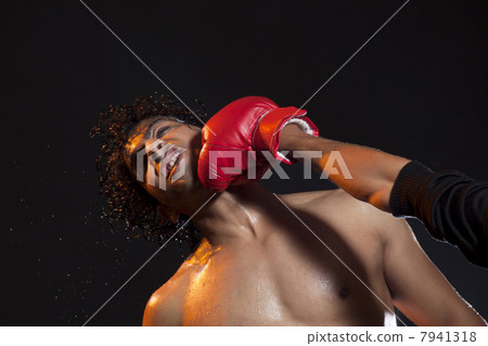 Male boxer striking opponent Male boxer striking opponent 7941318