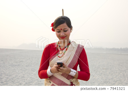 Bihu woman reading an sms on a mobile phone 7941321