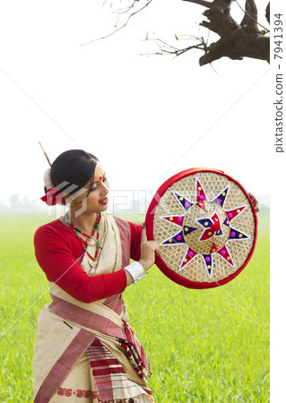 Bihu woman holding a jaapi 7941394