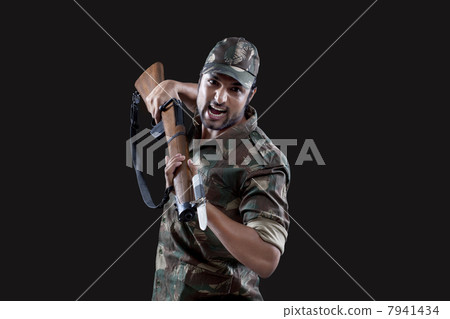 Angry young soldier holding gun Angry young soldier holding gun 7941434
