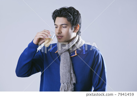 Young man holding glass of tea 7941459