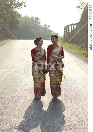 Bihu dancers holding hands and walking 7941485
