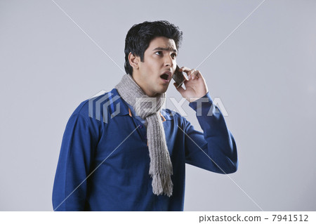 Surprised man having conversation on mobile phone Surprised man having conversation on mobile phone 7941512