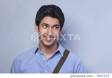 Smiling college student looking up Smiling college student looking up 7941533