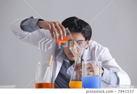 Scientist pouring liquid into flask Scientist pouring liquid into flask 7941537