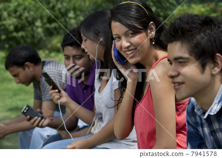 Group of young friends using cell phones 7941578