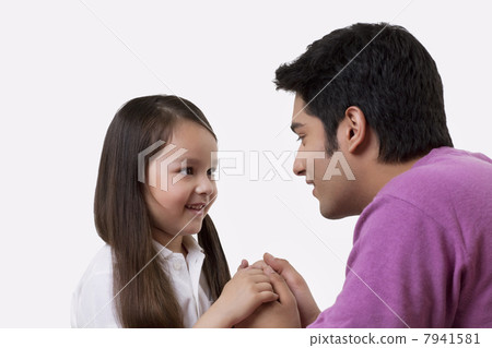 Close-up of father and daughter holding hands 7941581
