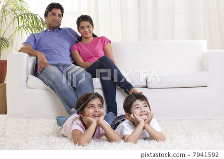 Smiling family watching TV Smiling family watching TV 7941592