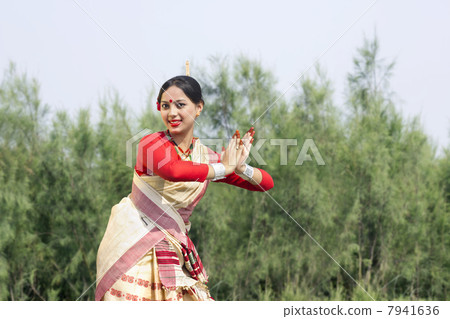 Woman performing Bihu dance 7941636